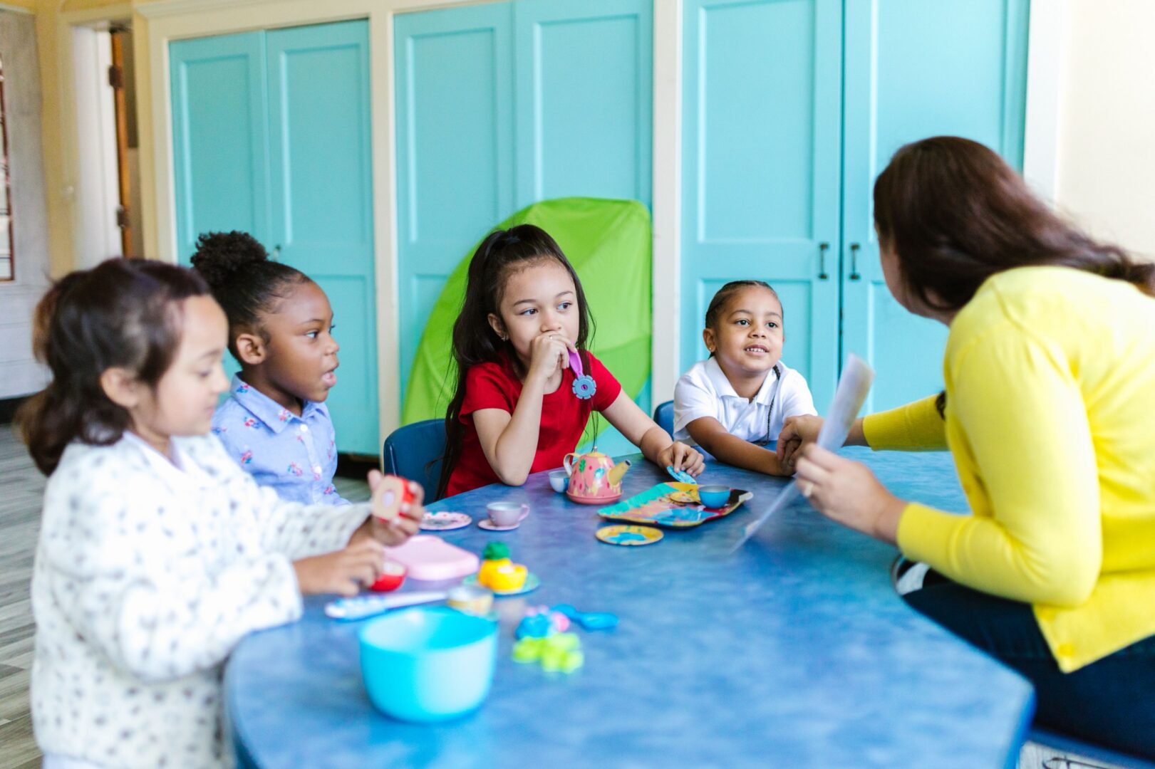 Kids learning at a blue table