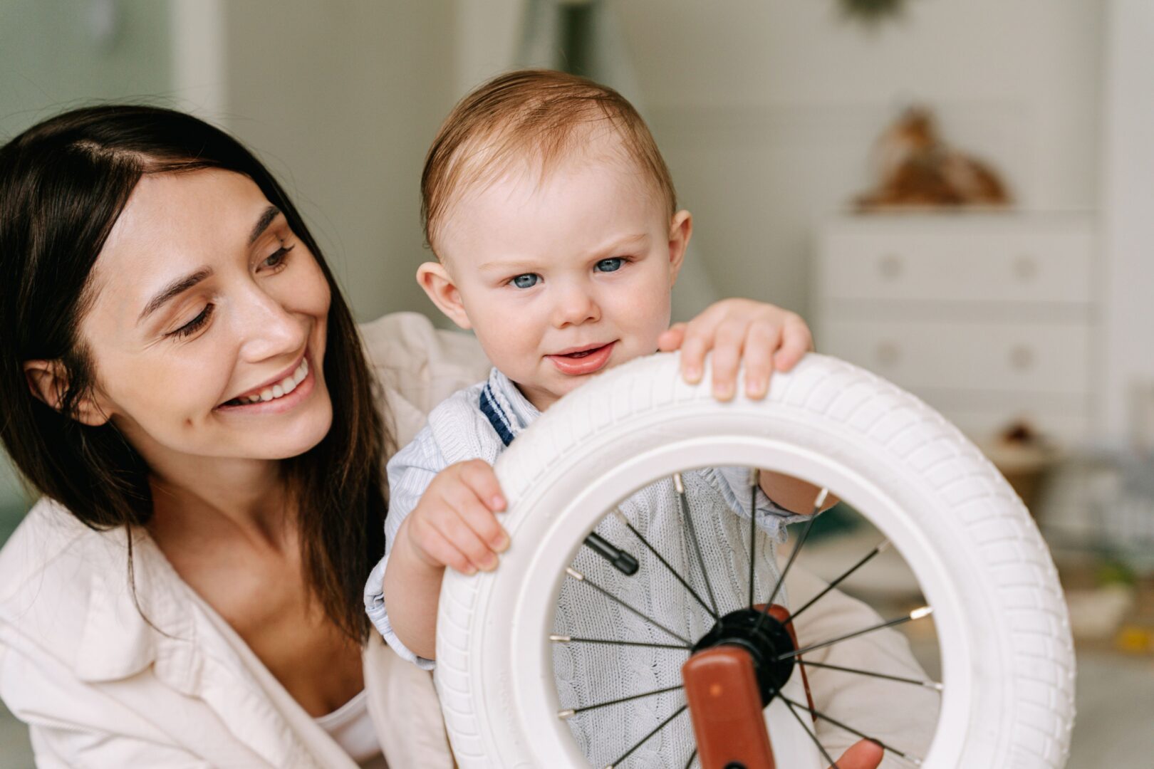 Mother and child with bicycle wheel